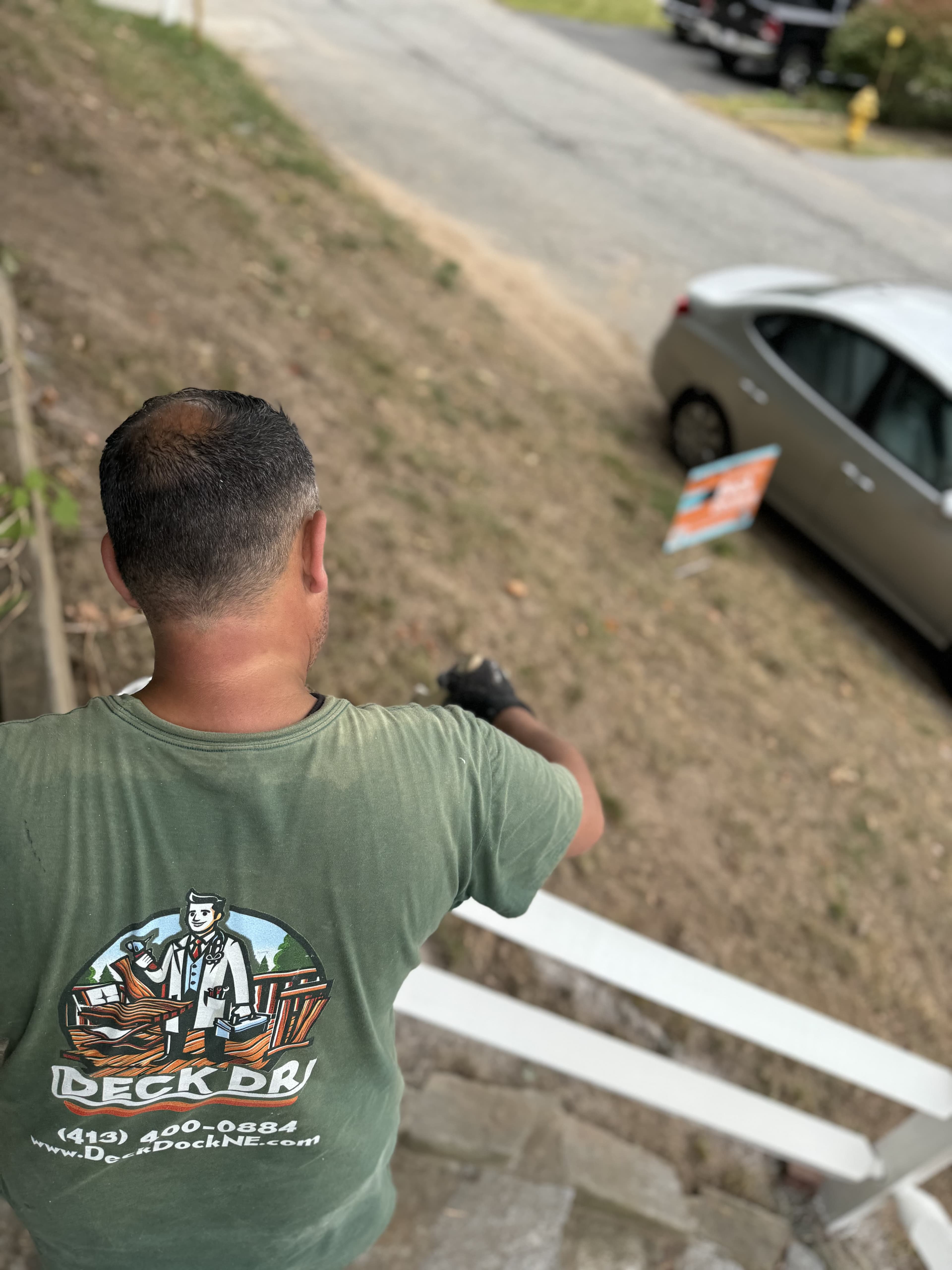 A Deck Doctors team member surveying a deck restoration site